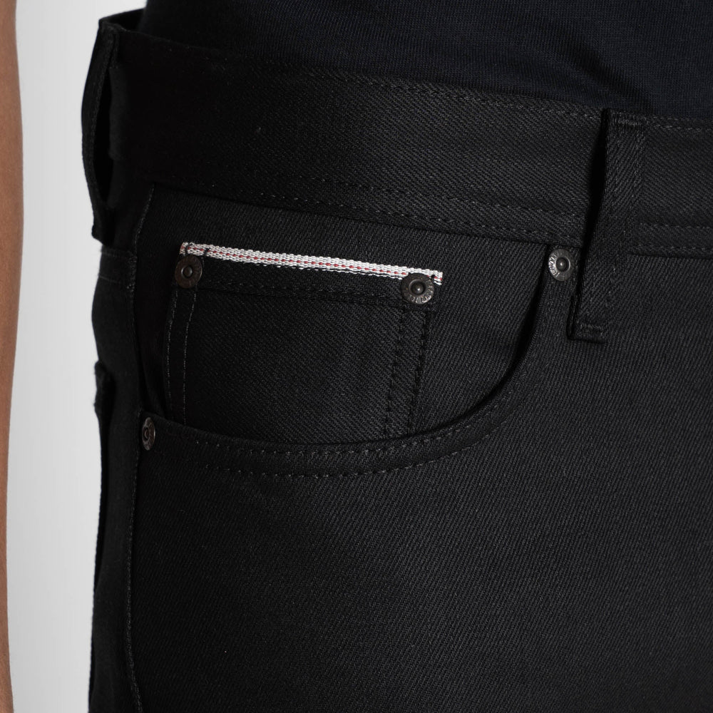 Close-up of a pocket of a black pair of jeans