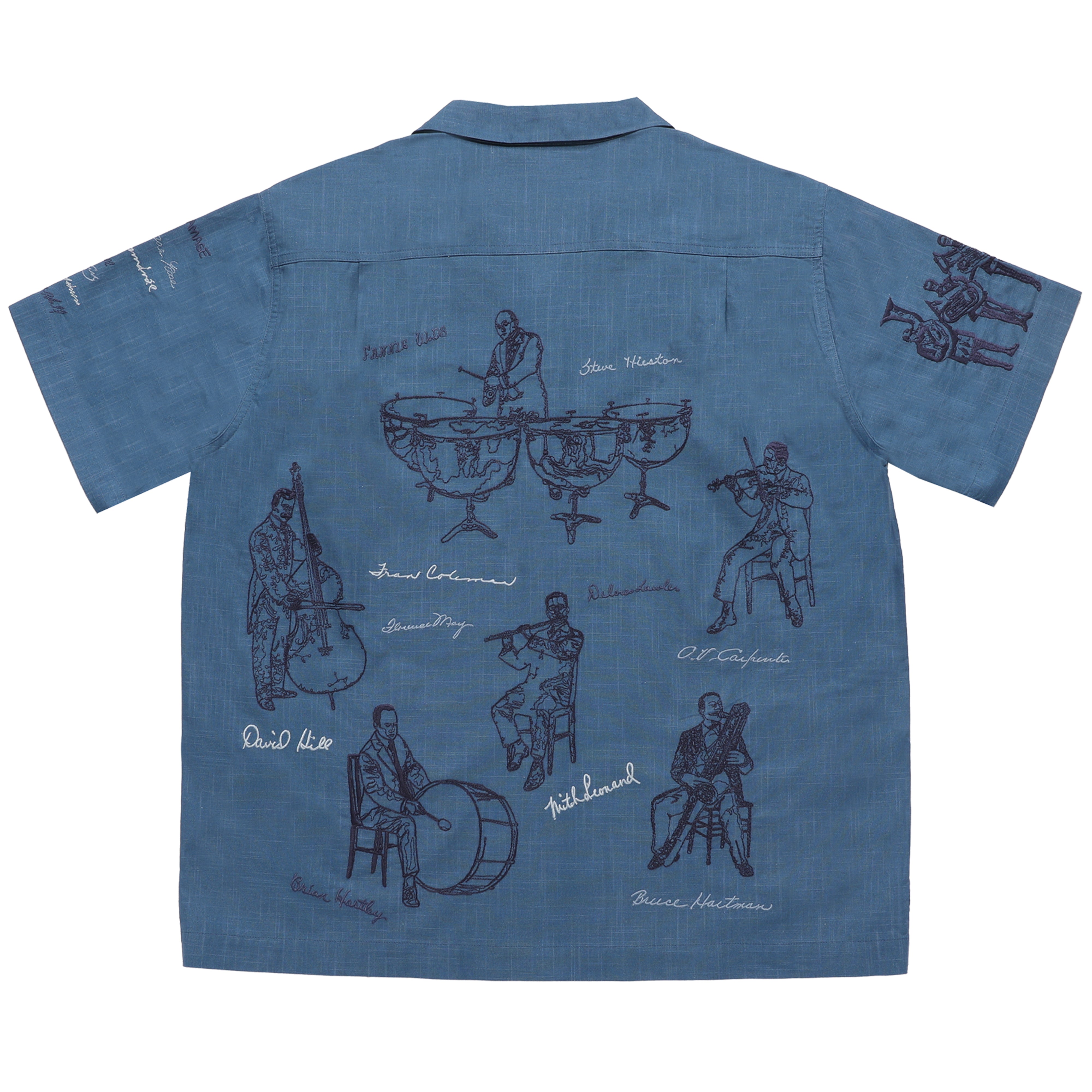 Blue shirt with black embroidered designs on a white background