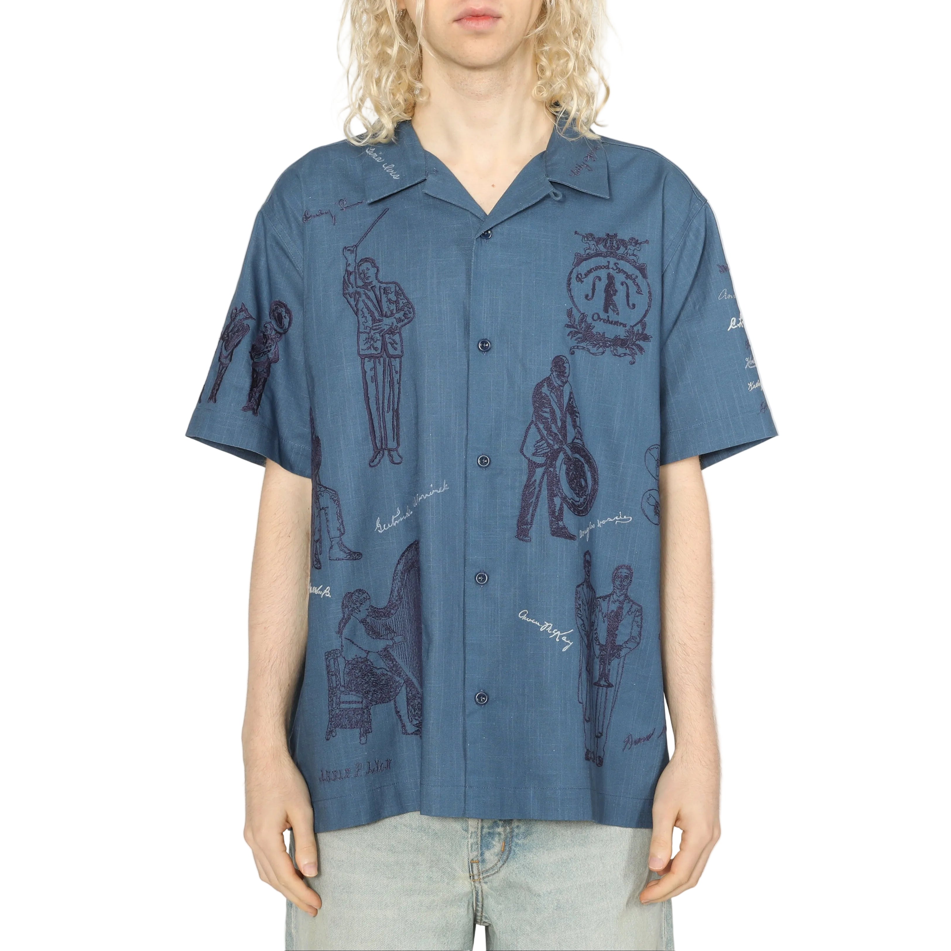 Person wearing a blue patterned shirt against a white background