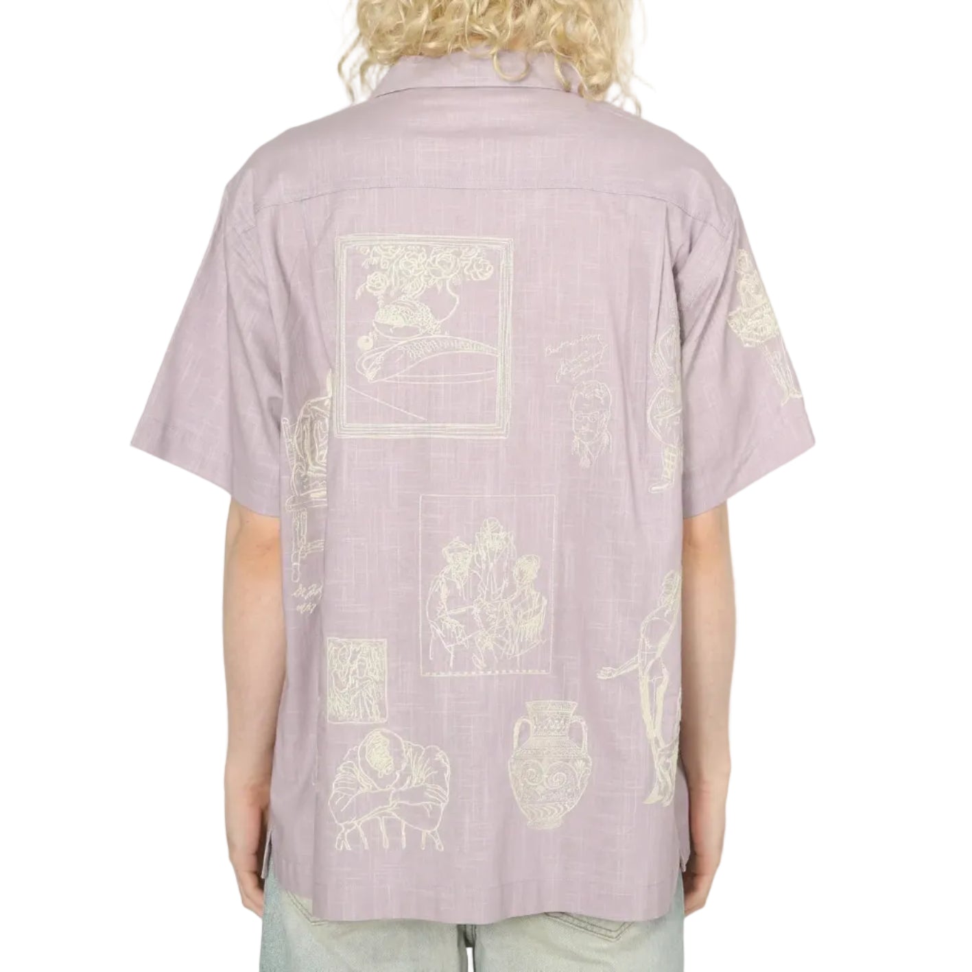 Person wearing a light purple shirt with white graphics on the back against a white background