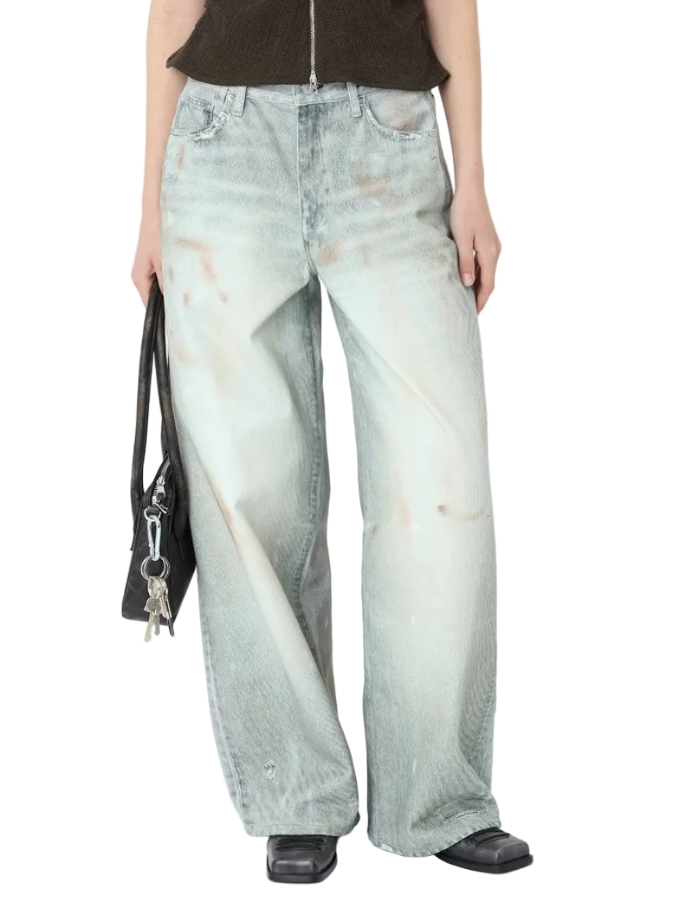 Person wearing light blue jeans and a black top on a white background