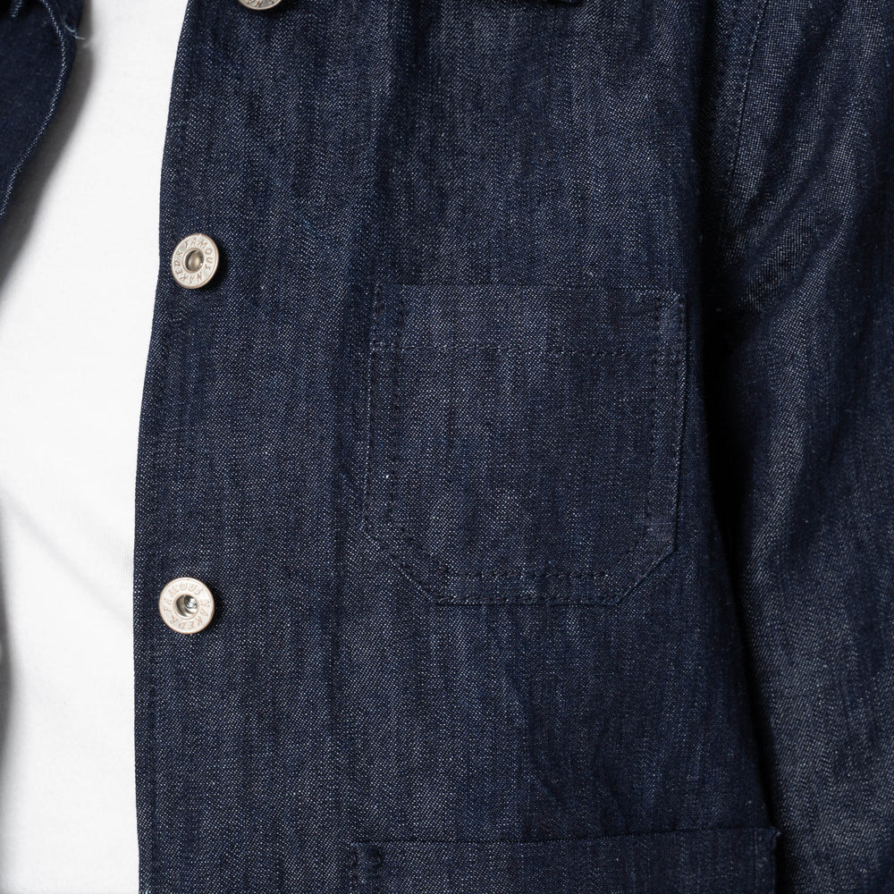 Close-up of a dark denim shirt with button