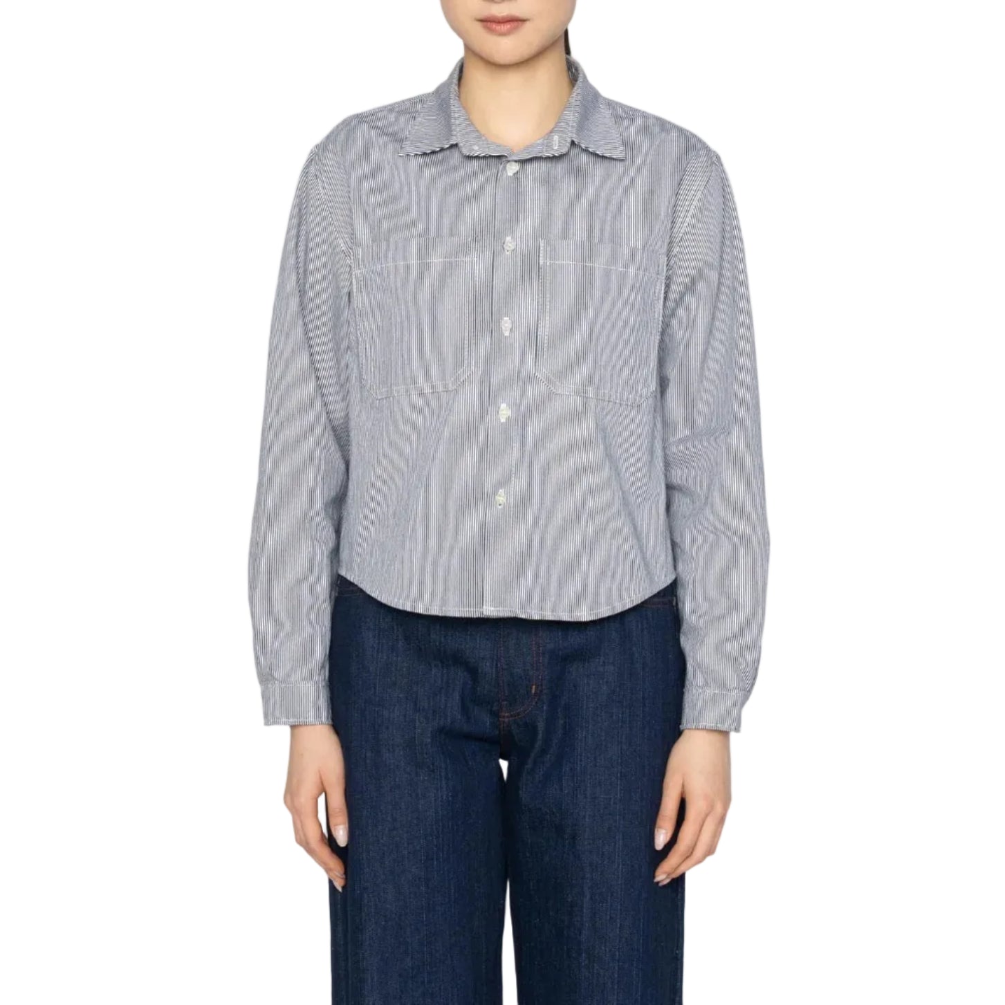 Person wearing a blue and white striped shirt and dark jeans on a white background