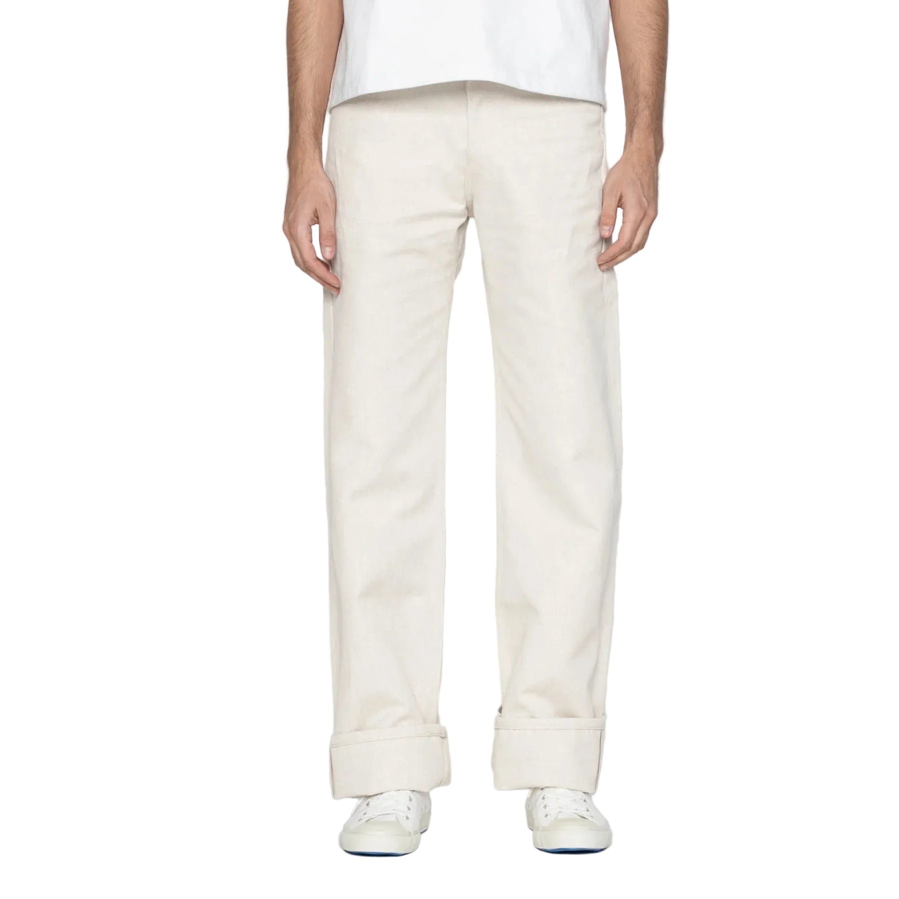 Person wearing white pants on a plain background