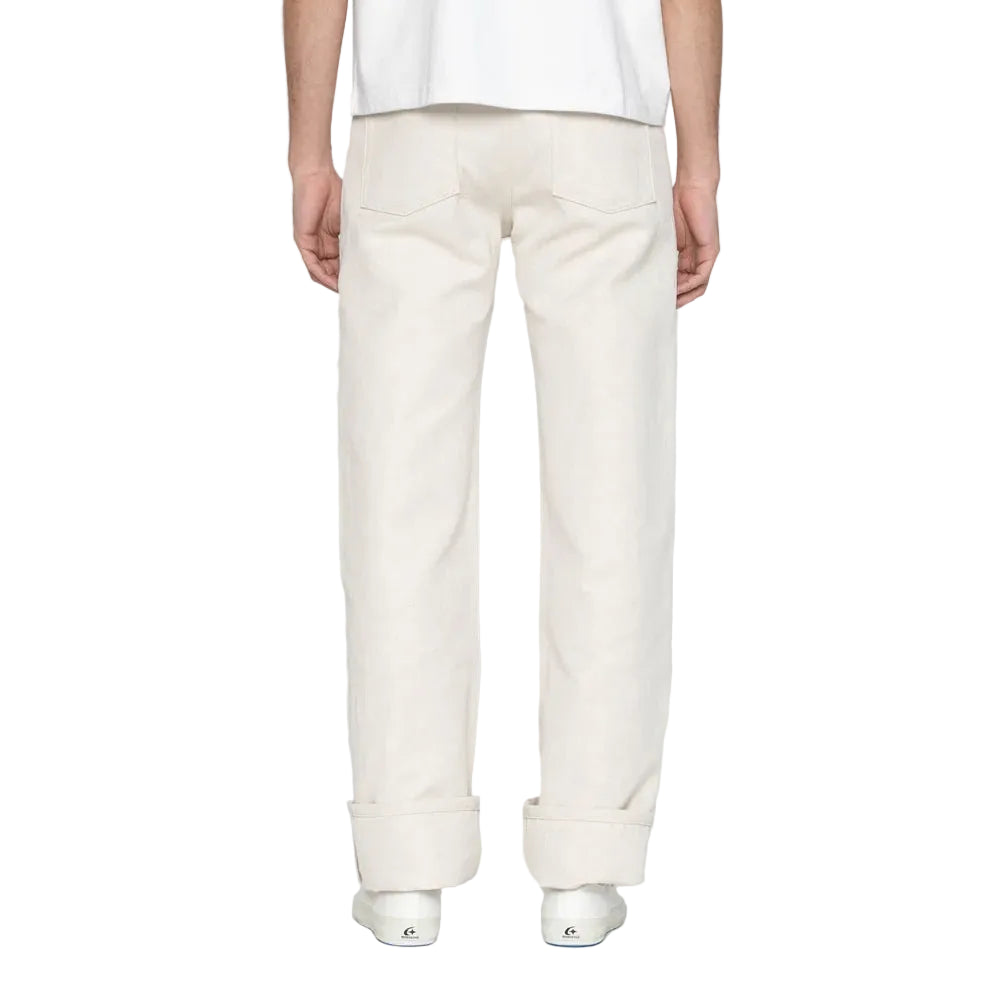 Person wearing white pants on a plain background