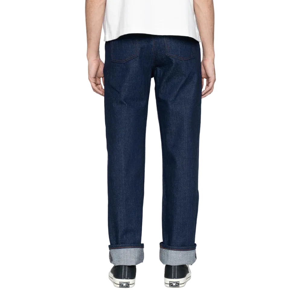Person wearing dark blue jeans on a white background