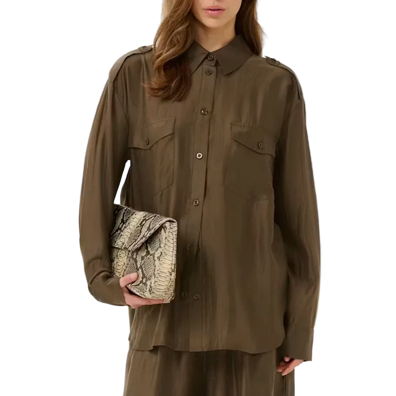 Woman wearing a brown outfit holding a clutch on a white background