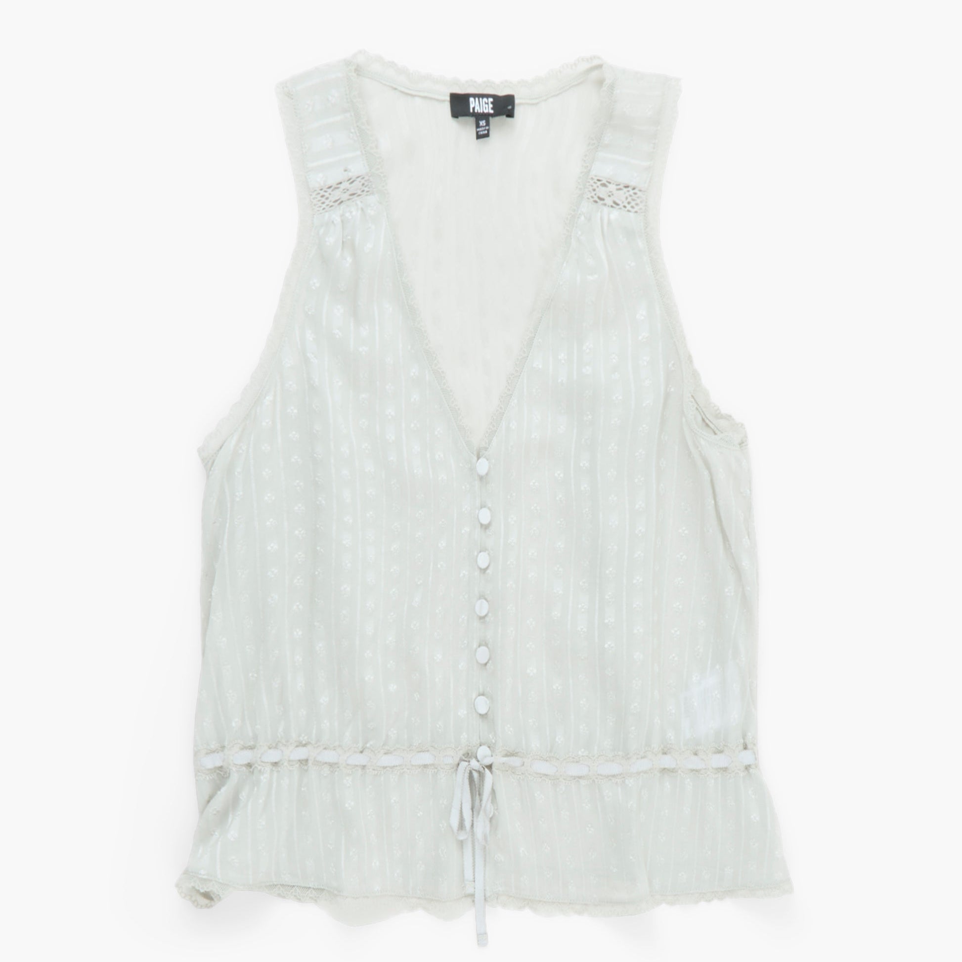Light green sleeveless top with buttons on a white background