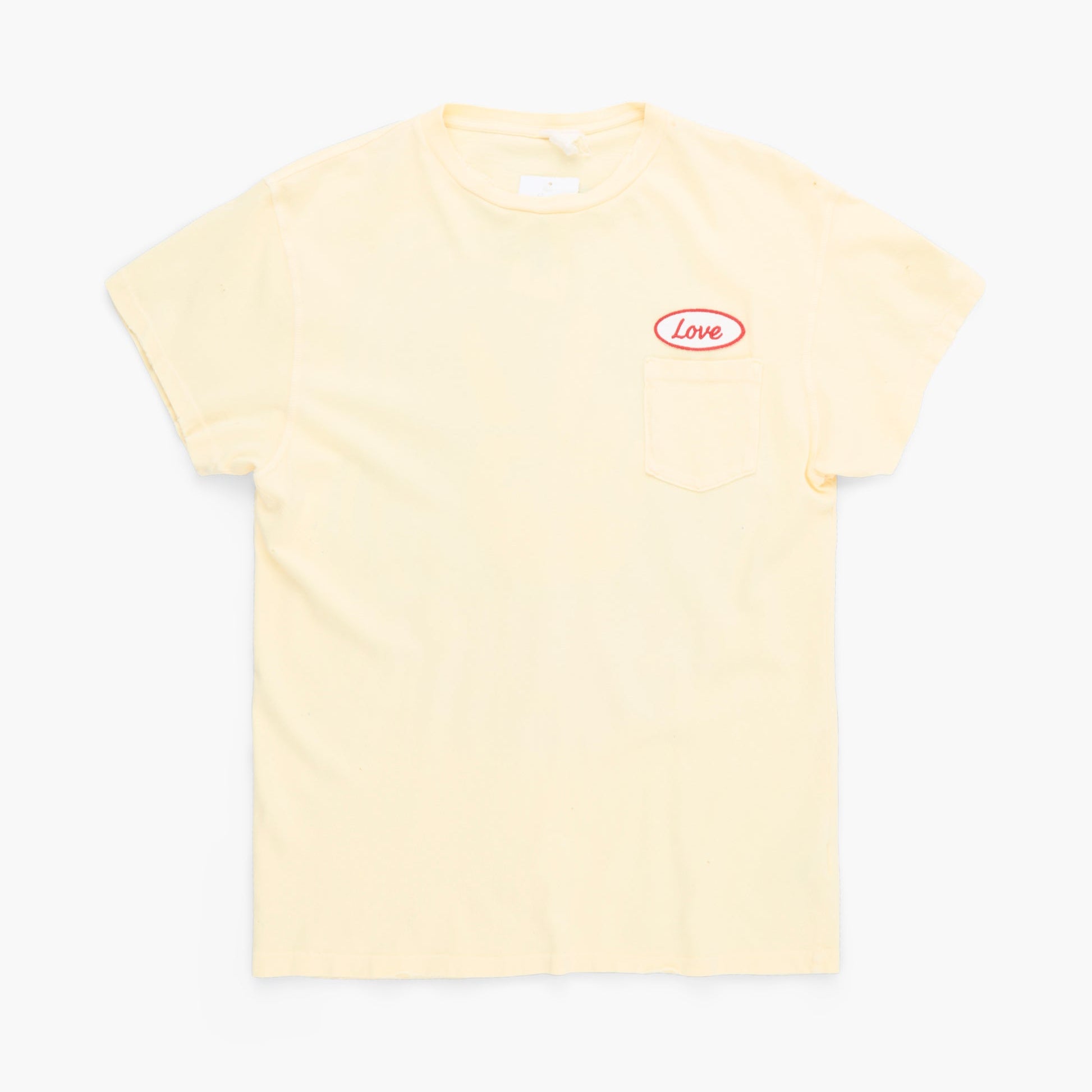Beige t-shirt with a small red logo on a white background
