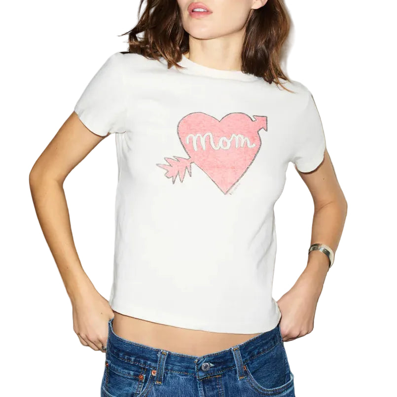 Woman wearing a white t-shirt with a pink heart design on a plain background