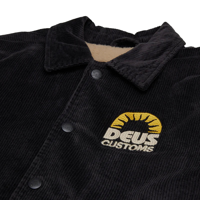 Black corduroy jacket with 'Deus Customs' logo on a white background