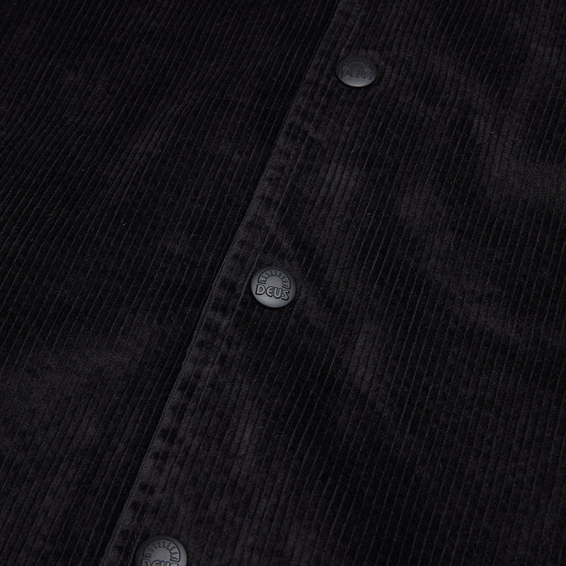 Close-up of a black corduroy shirt with button details