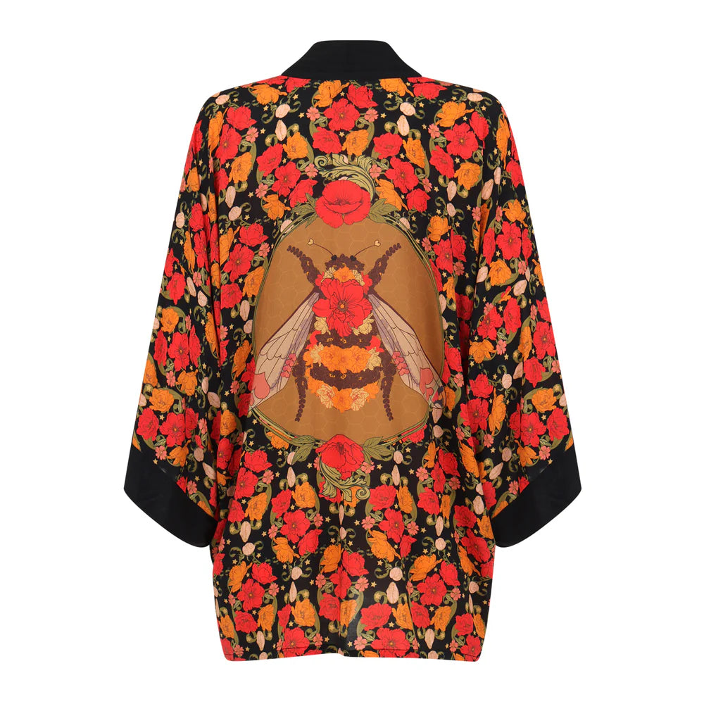Colorful kimono-style garment with floral and bee design on a white background
