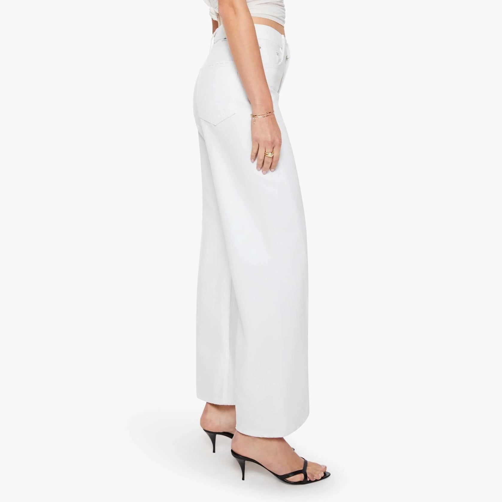 Woman wearing a white top and pants on a white background