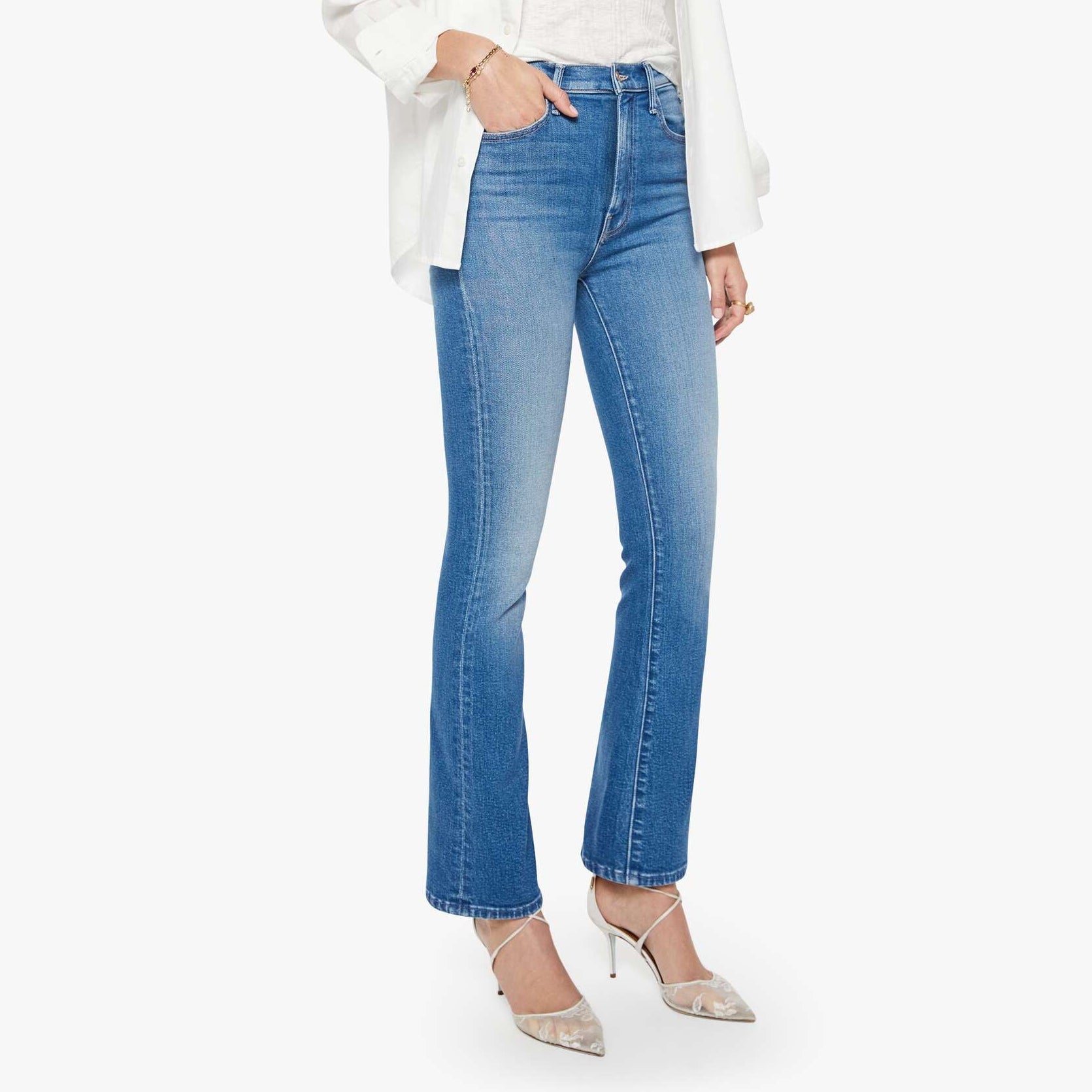 Woman wearing a white blouse and blue jeans on a white background