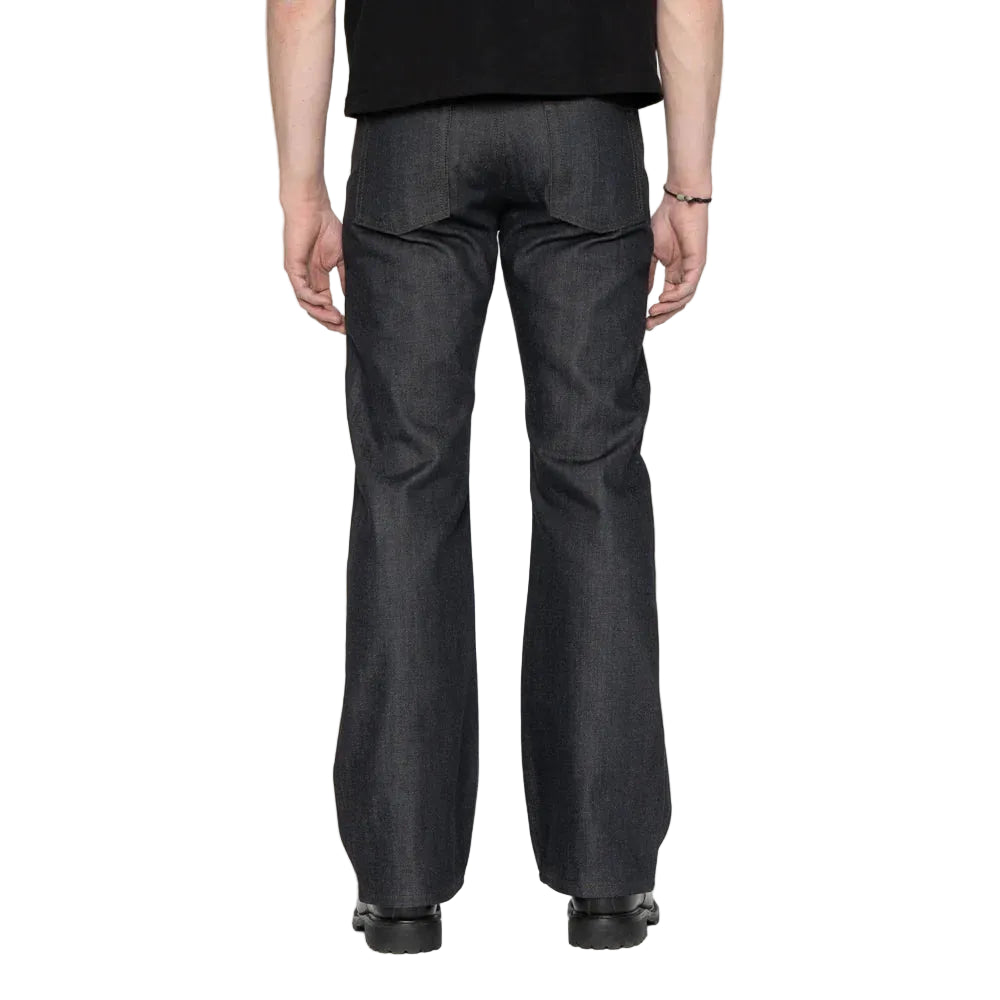 Person wearing dark blue jeans on a white background