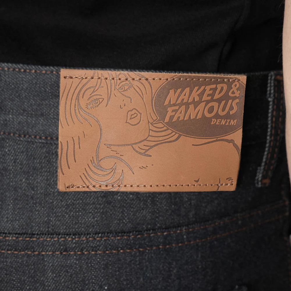 Branded leather patch on a dark blue jean