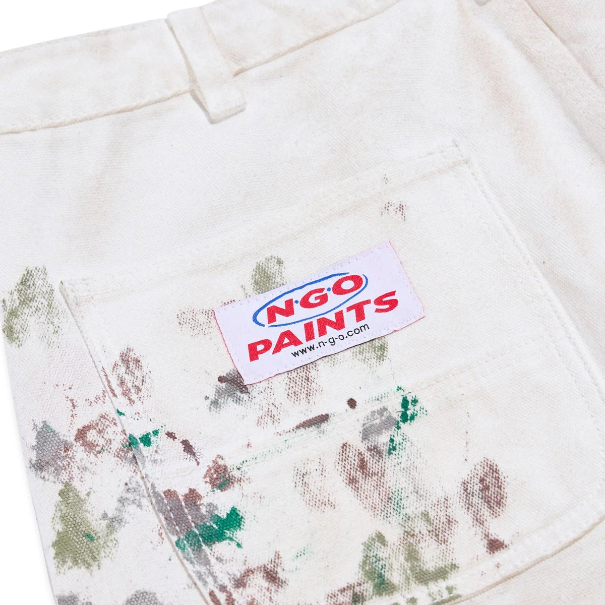 Dirty white pants with paint stains and an NGO Paints label.