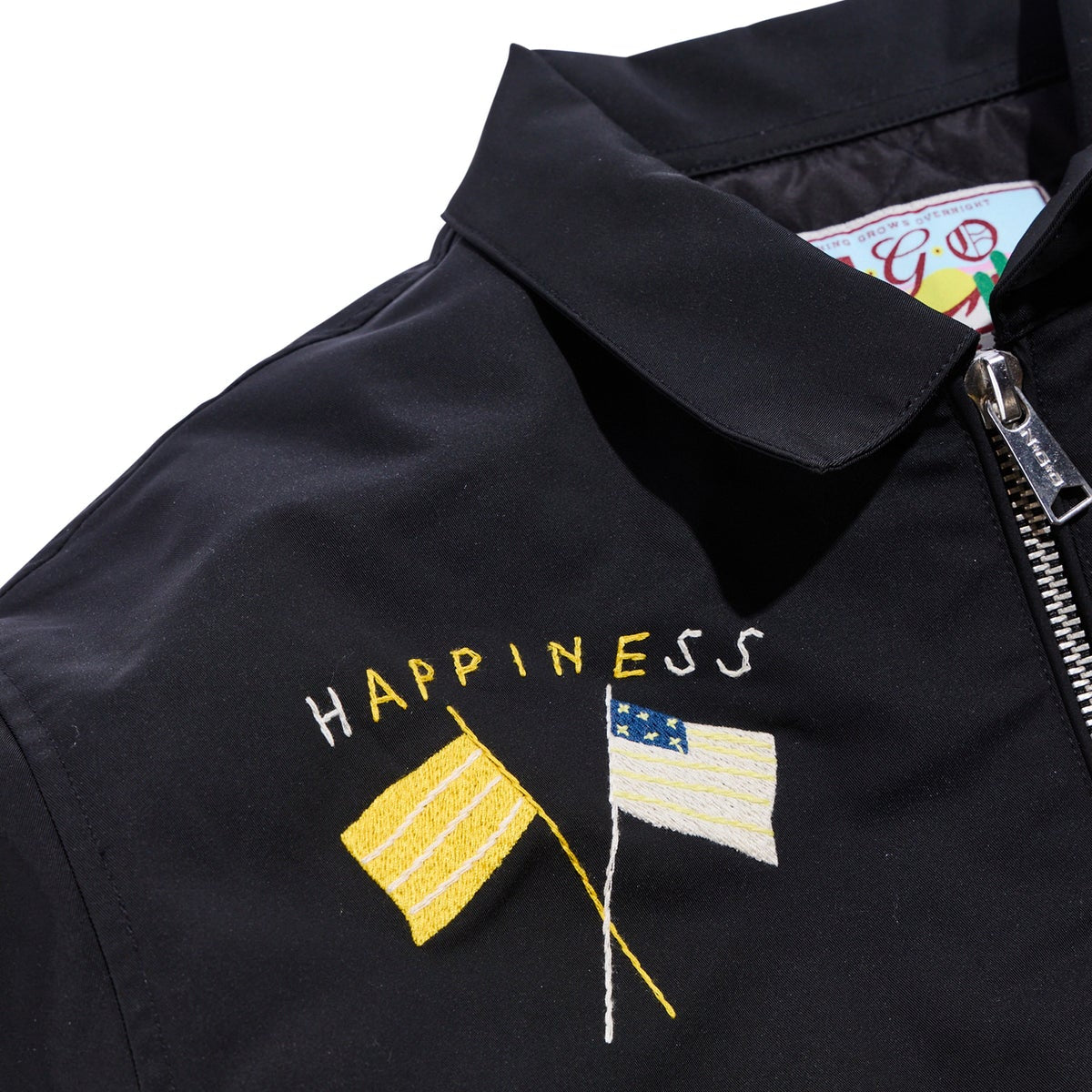 Black jacket with embroidered flags and 'Happiness' text on a white background