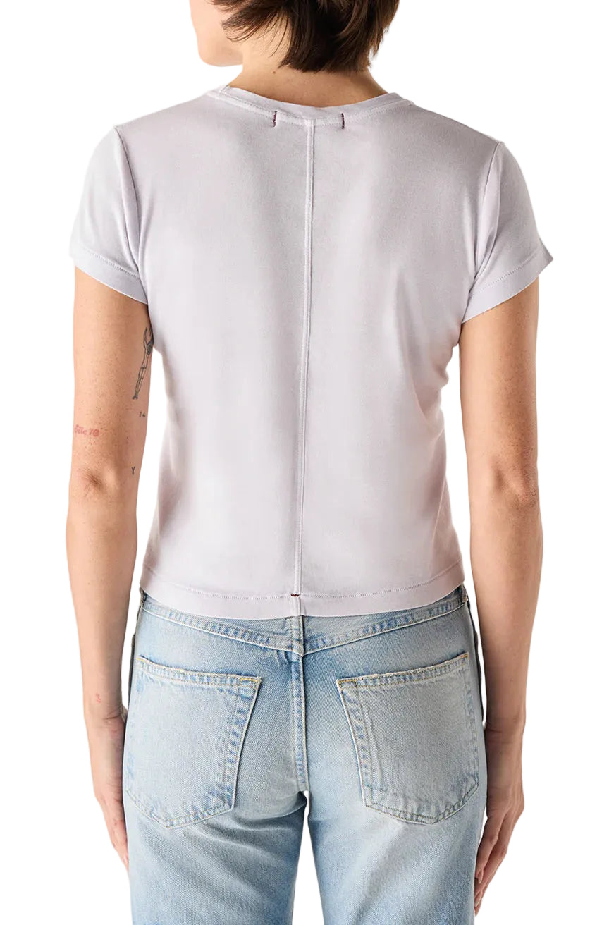 Person wearing a light purple t-shirt and light blue jeans on a white background
