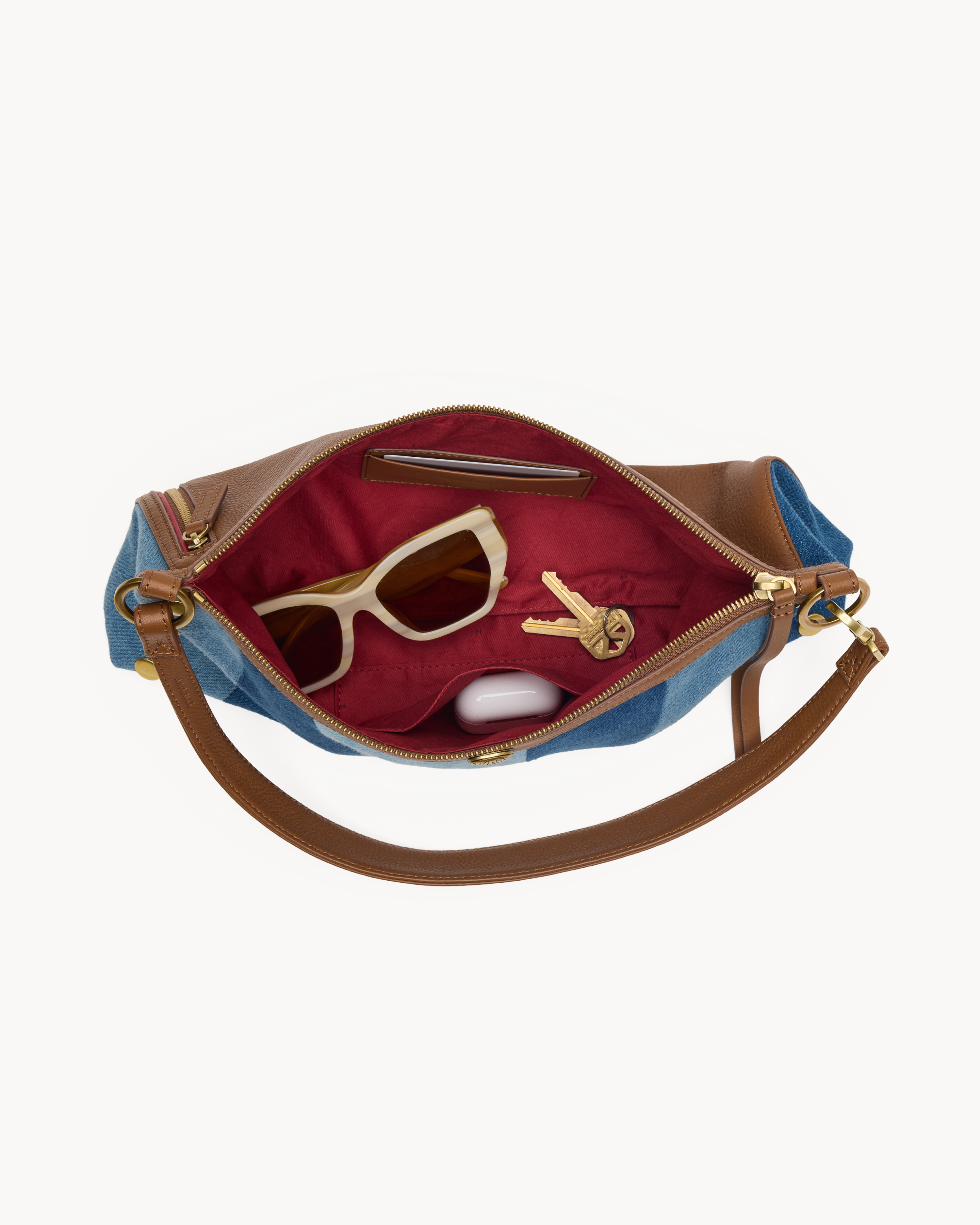 Interior view of a blue striped convertible bag with brown and gold accents