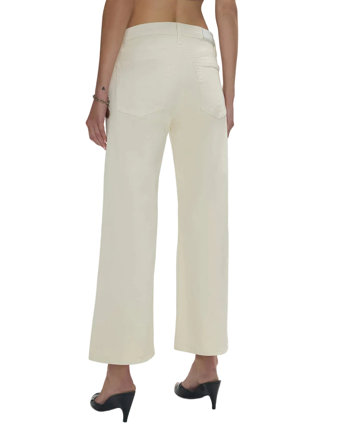 Model in white wide-leg jeans on a white background