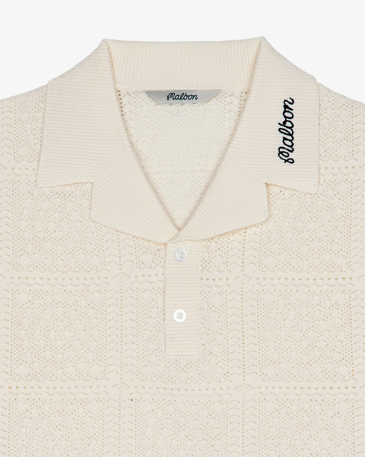 Close-up of a textured beige shirt with 'Malbon' branding on a white background