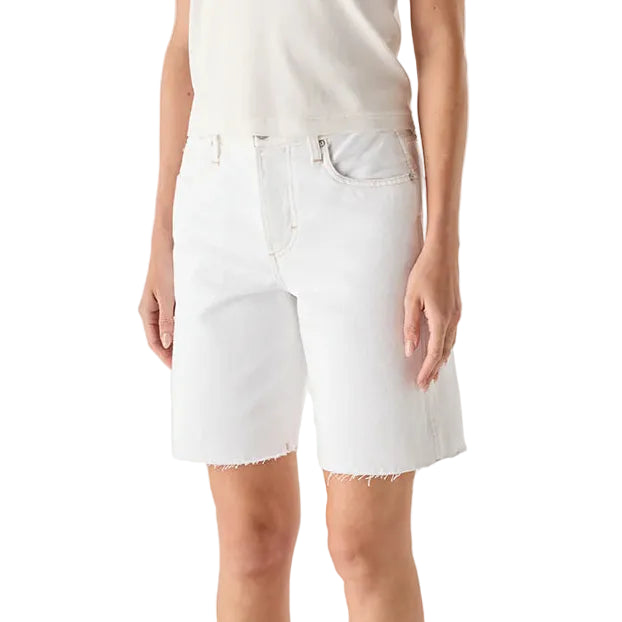 Person wearing a white t-shirt and white shorts on a plain background