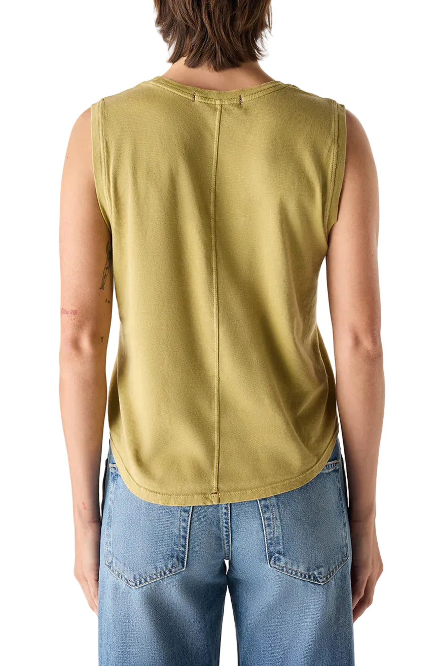Person in a green sleeveless tank and blue jeans on a white background