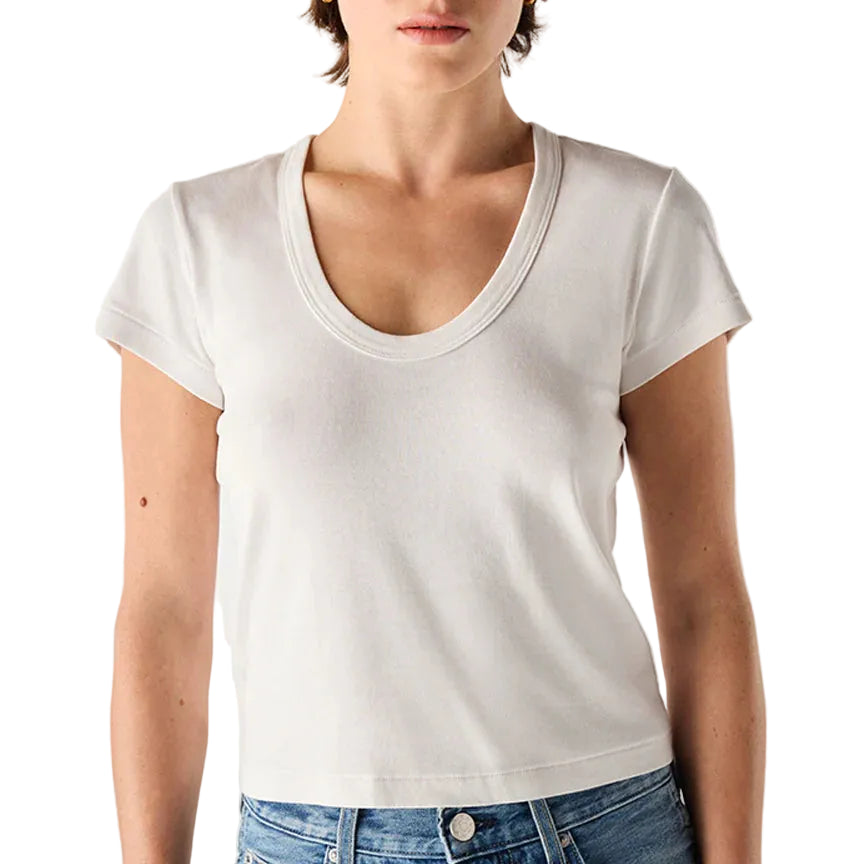 Person wearing a plain white t-shirt and blue jeans on a light background