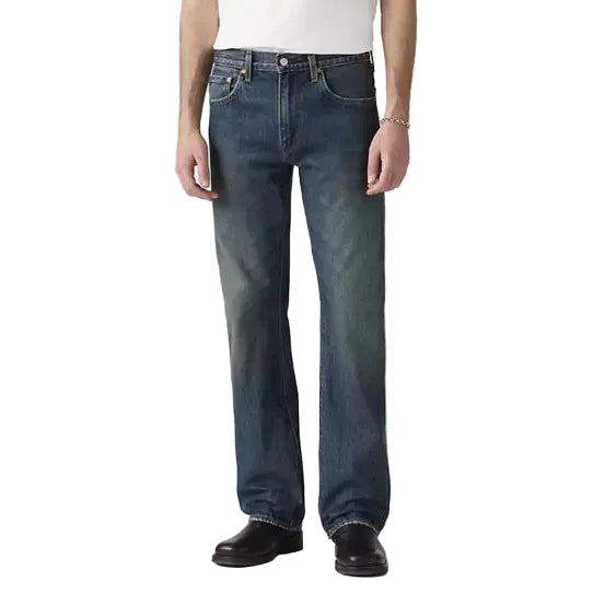 Person wearing a white t-shirt and blue jeans on a plain background