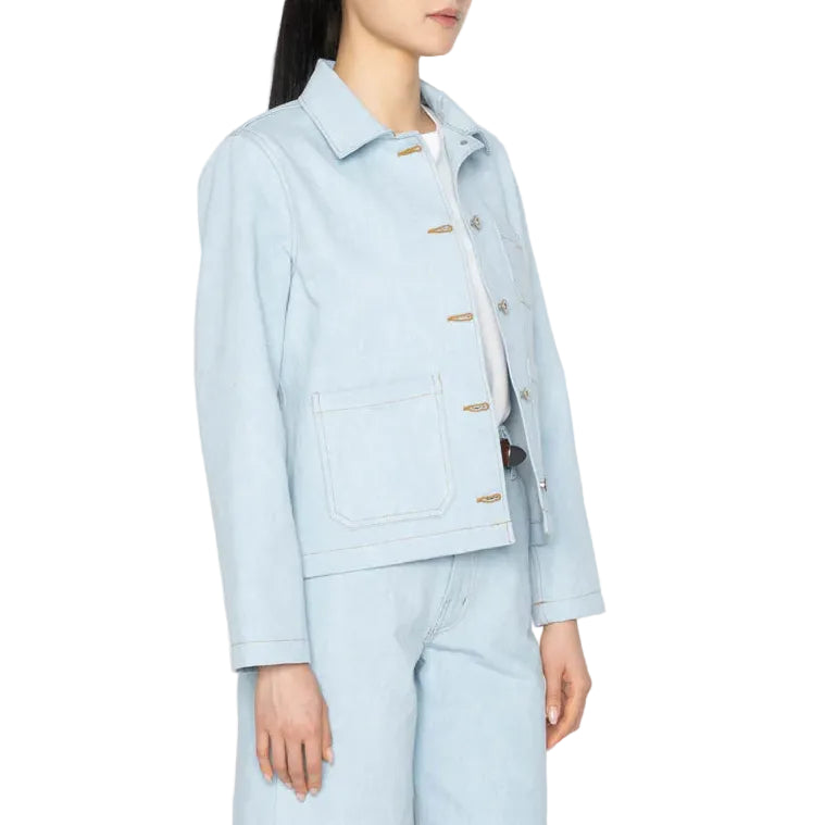 Woman wearing a light blue outfit with a jacket and shorts on a white background