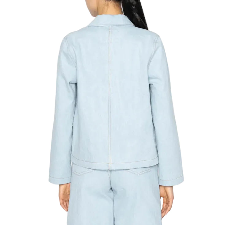 Person wearing a light blue denim jacket and shorts on a white background
