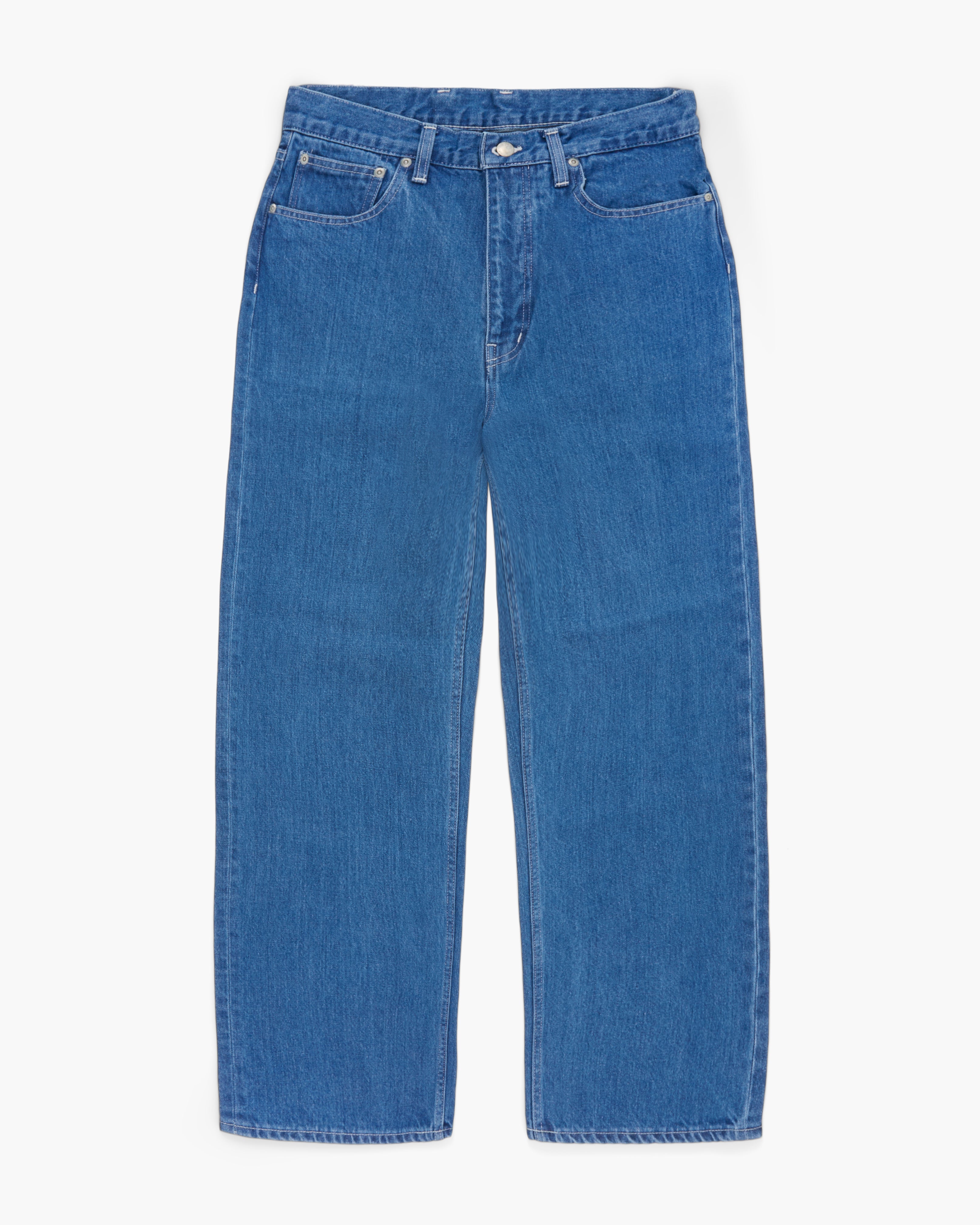 Wide leg blue jeans on a white background