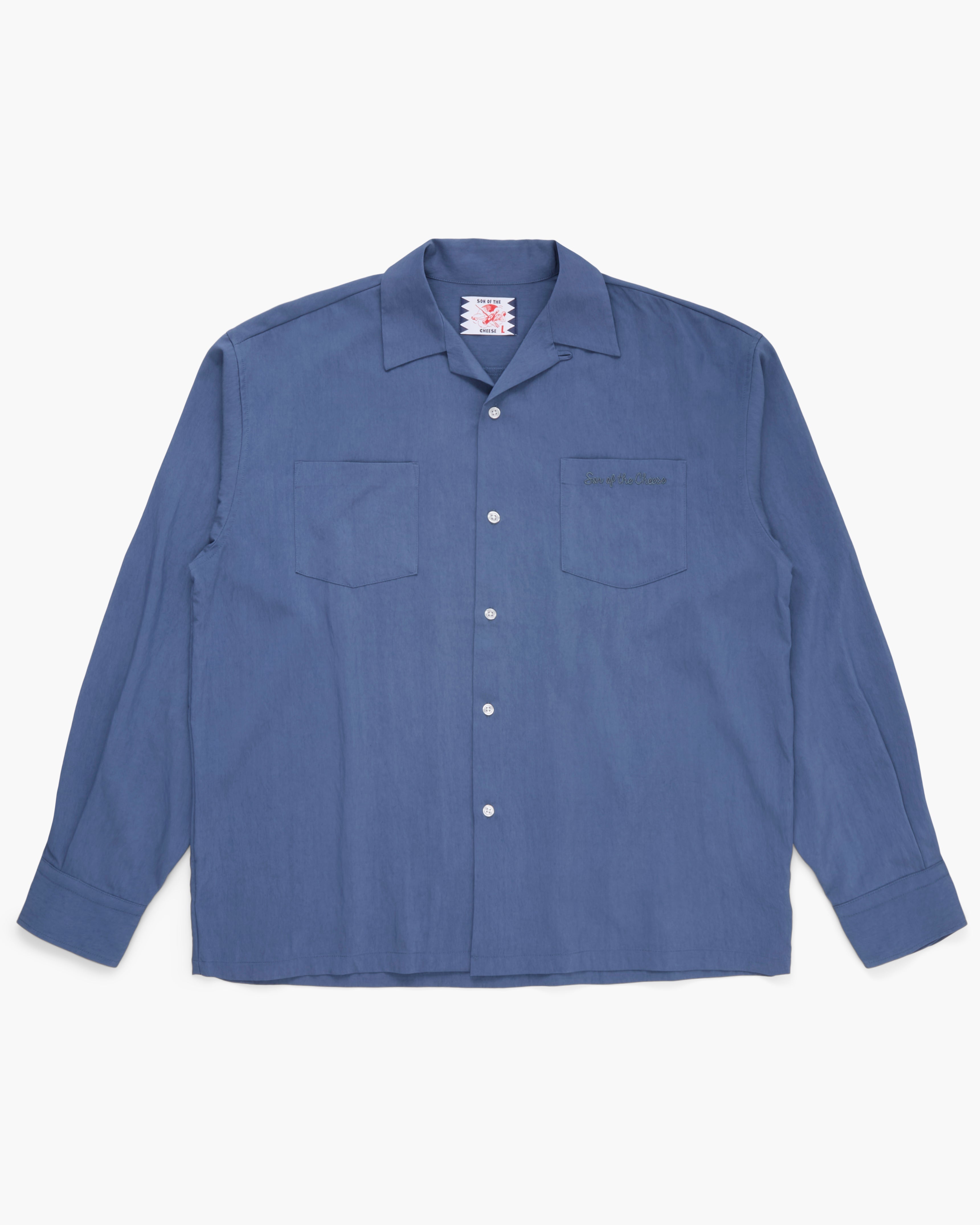 Blue button down shirt on a white background