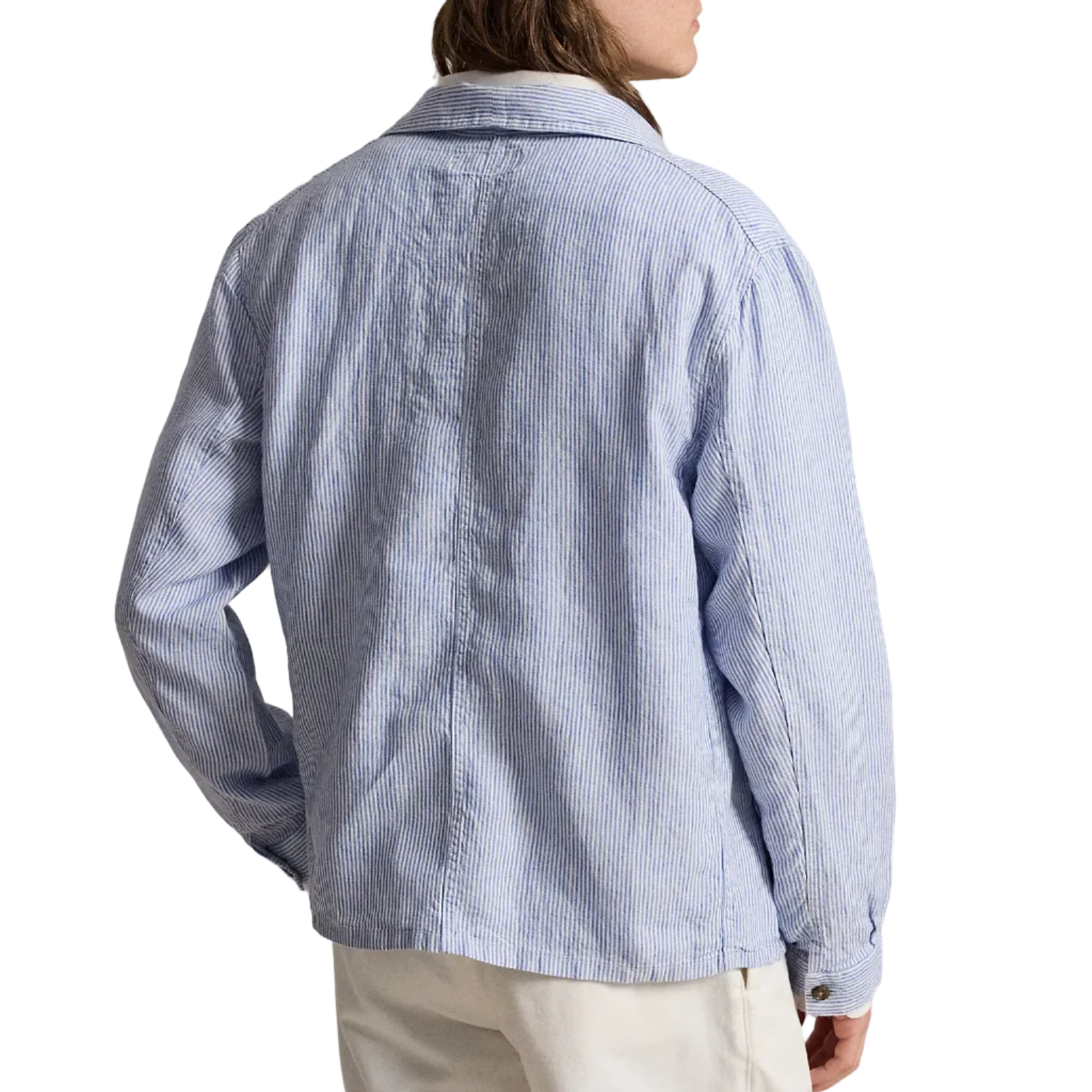Person wearing a light blue striped shirt and white cap, standing against a white background