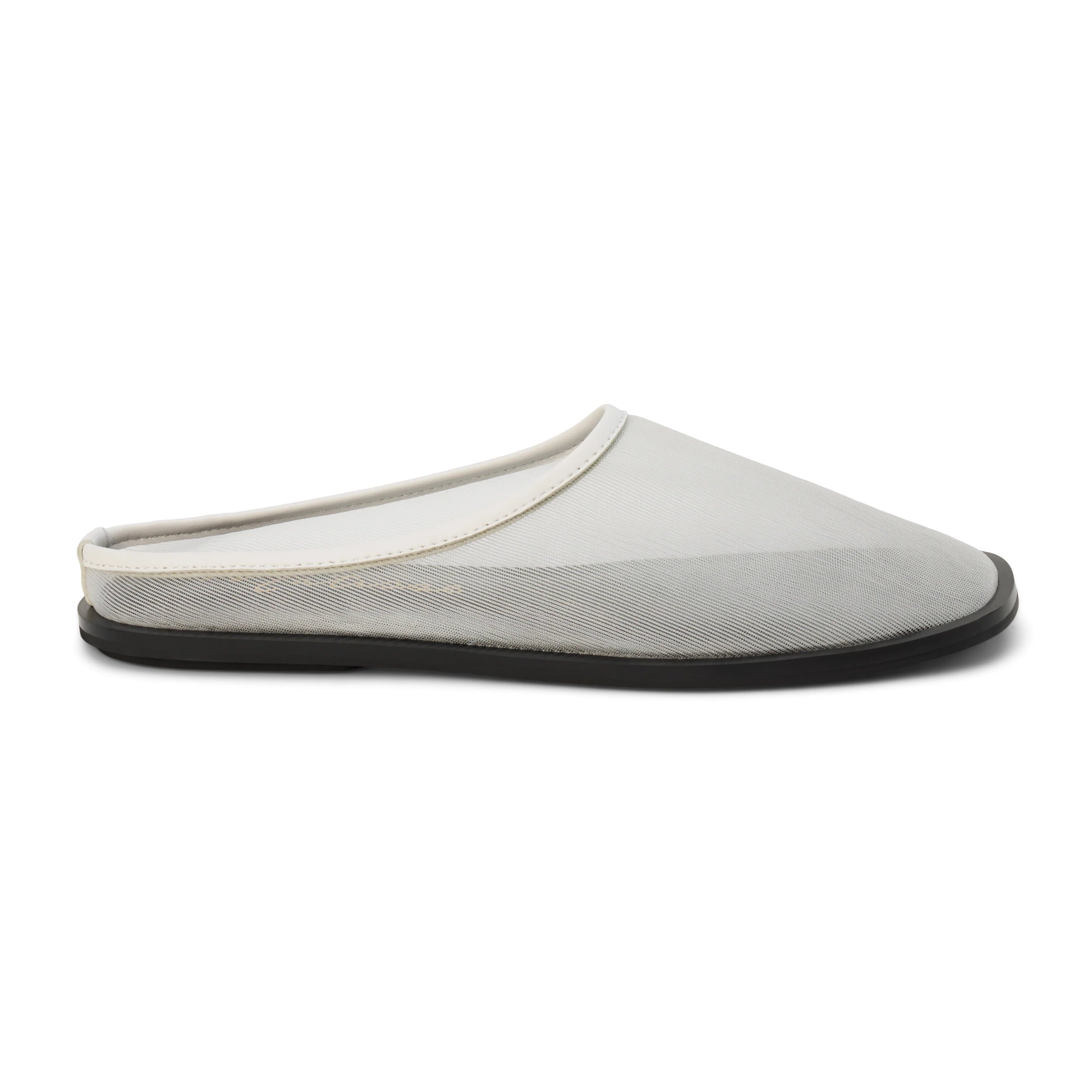 White mesh mule with a flat black sole on a white background
