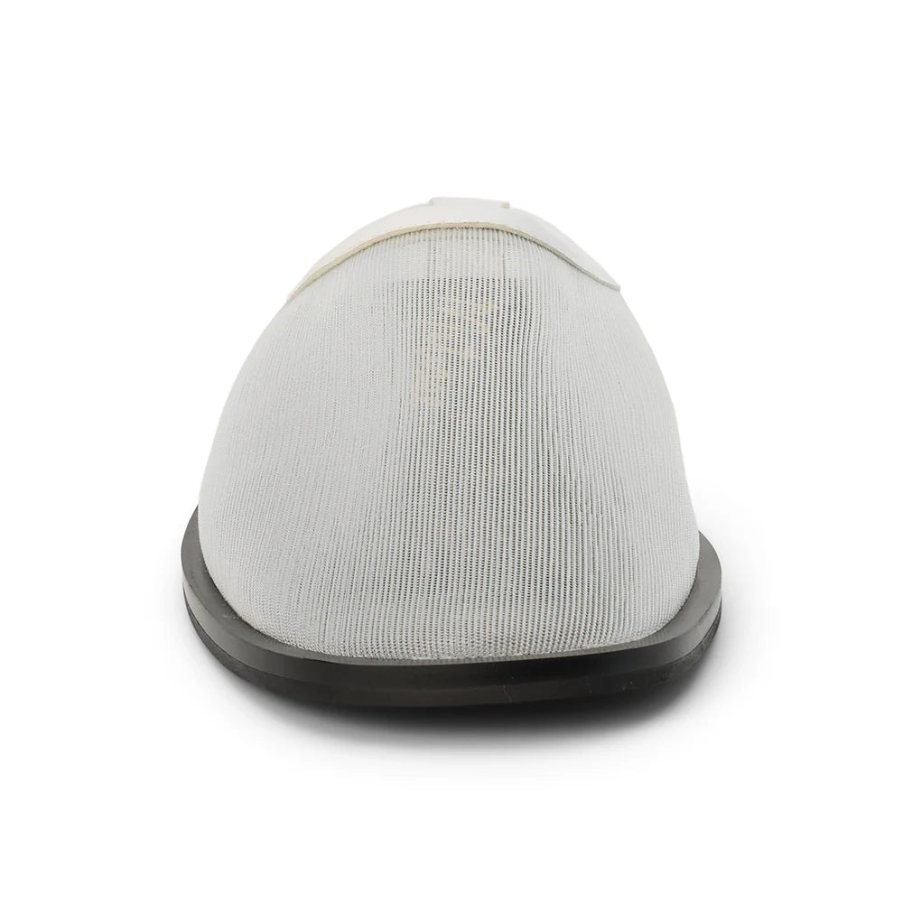 Front view of a white mesh mule with a flat black sole on a white background
