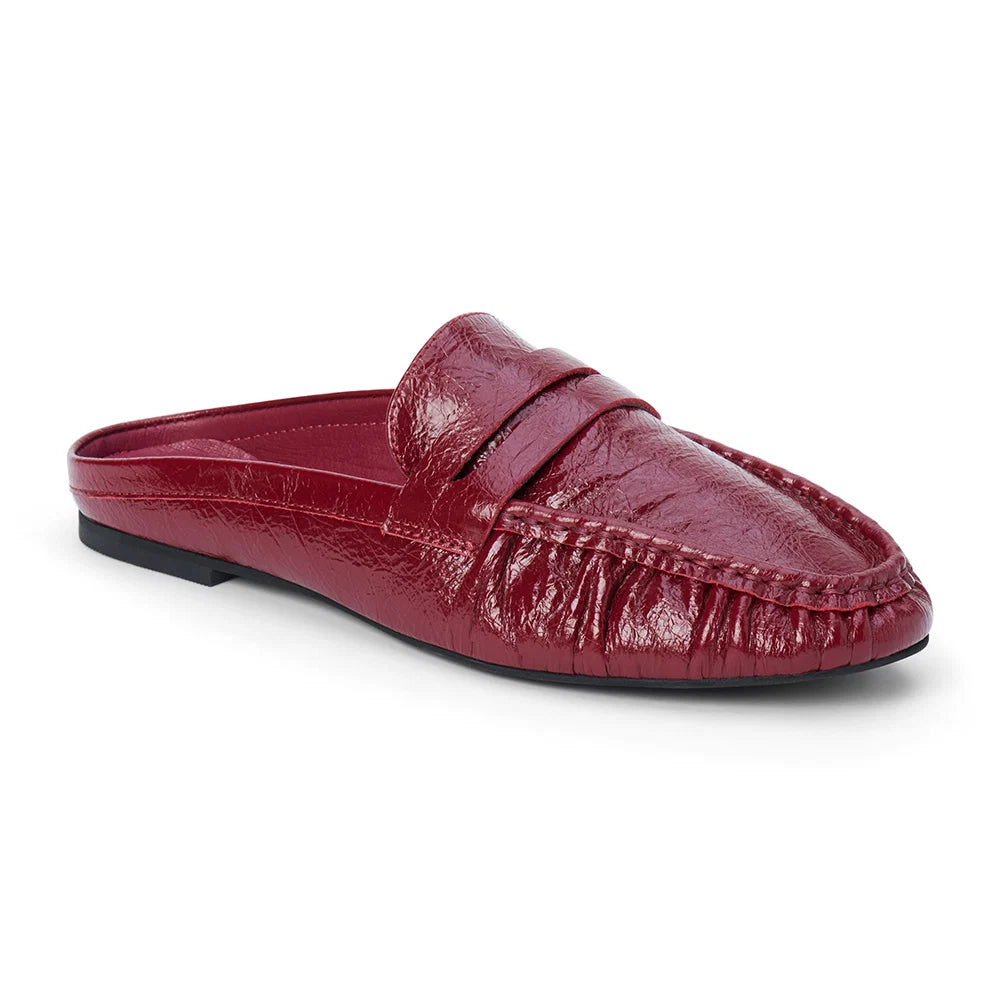 Three-quarter view of a glossy red leather penny loafer mule on a plain white background.