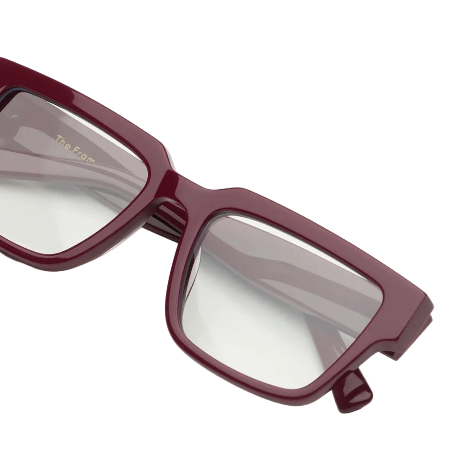 Maroon eyeglasses on a white background