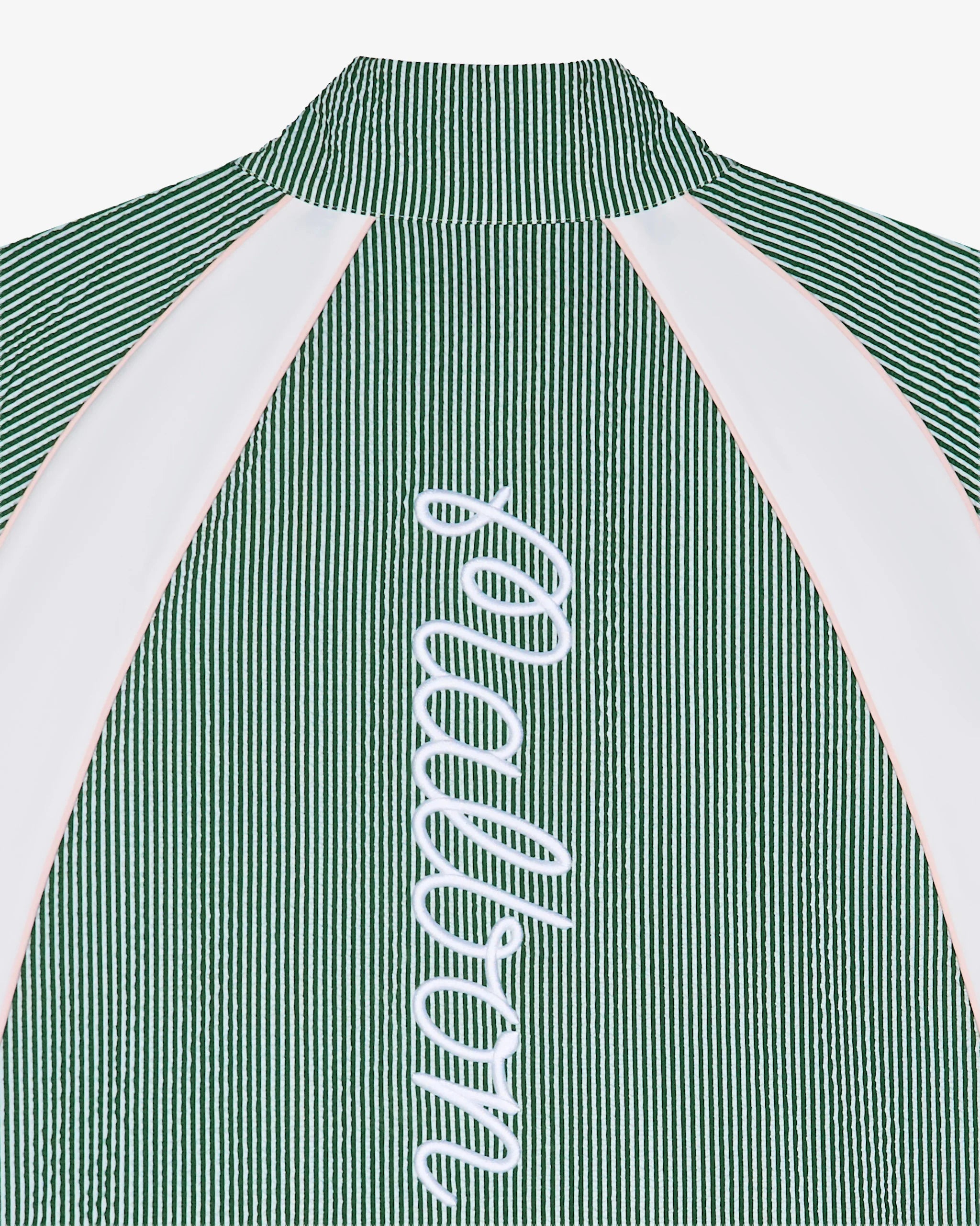 Close-up of the back of a green seersucker pullover jacket with a 'Malbon' logo down the back on a white background