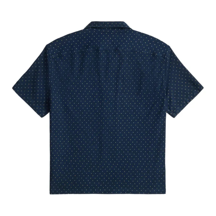 A short-sleeve button-up shirt in dark navy blue with a small white geometric dot pattern, shown from the back on a plain white background.