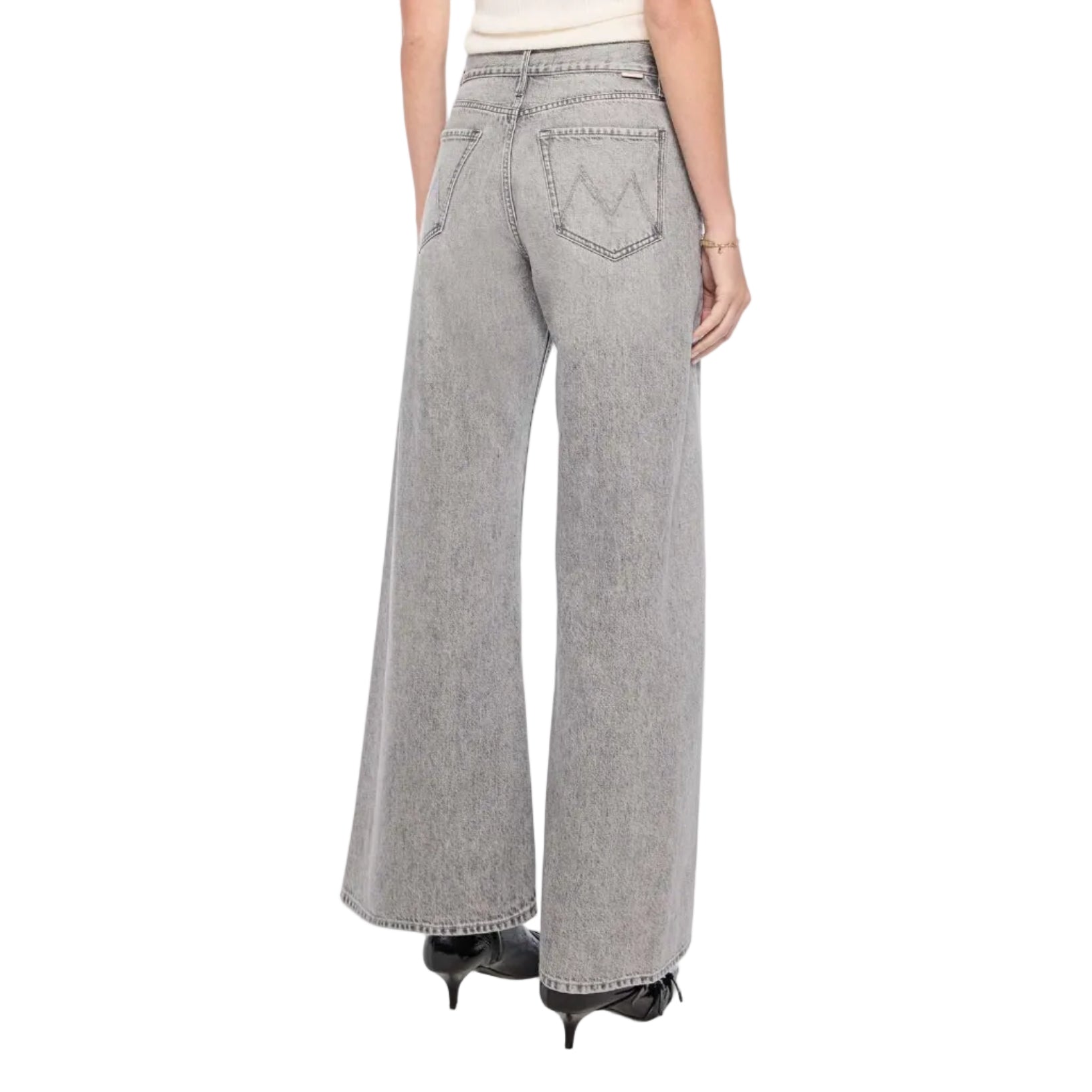Woman wearing gray wide-leg pants and a white top on a white background