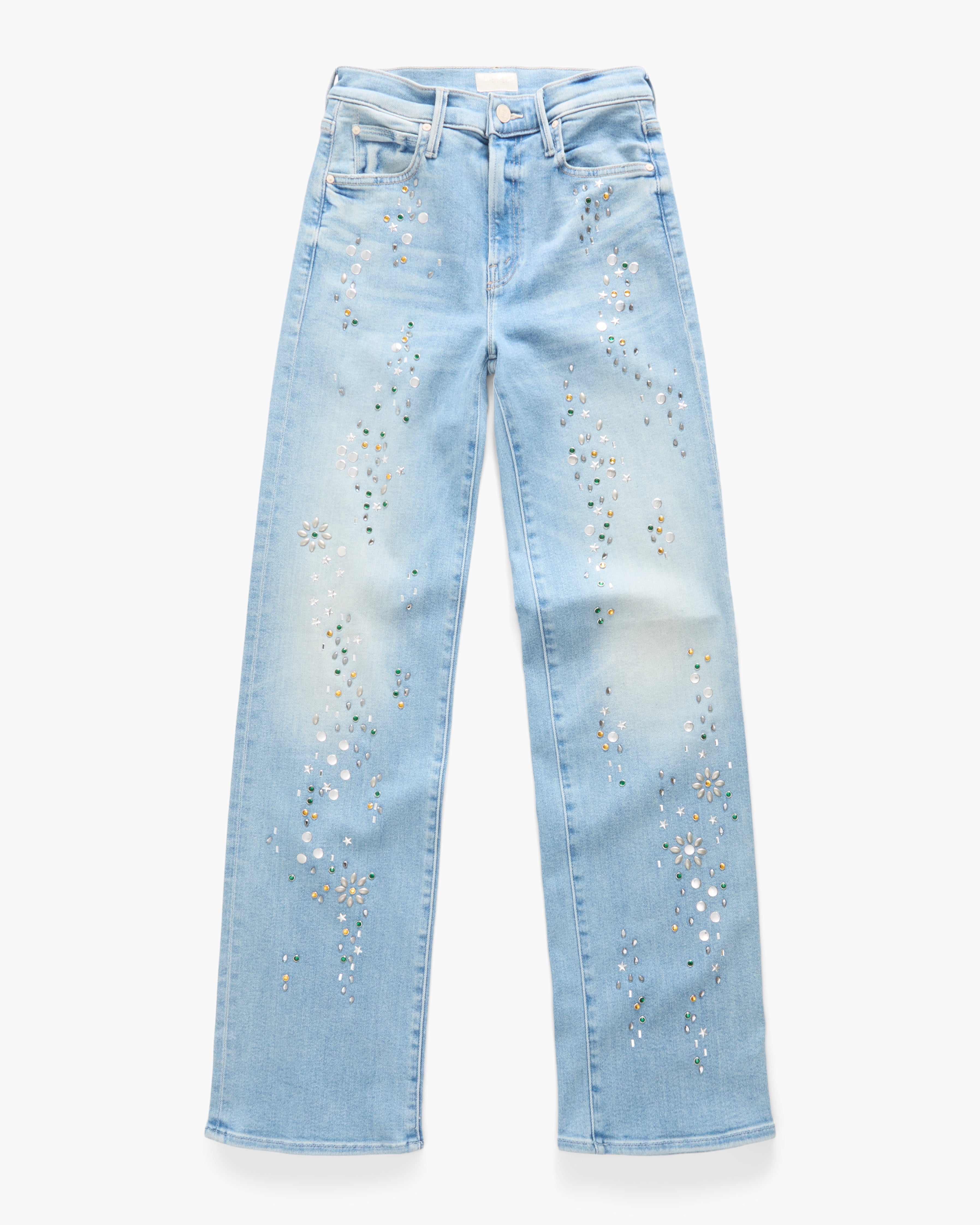 Light blue denim jeans with white and gold rhinestone floral embellishments running down the front of each leg, shown flat against a white background.