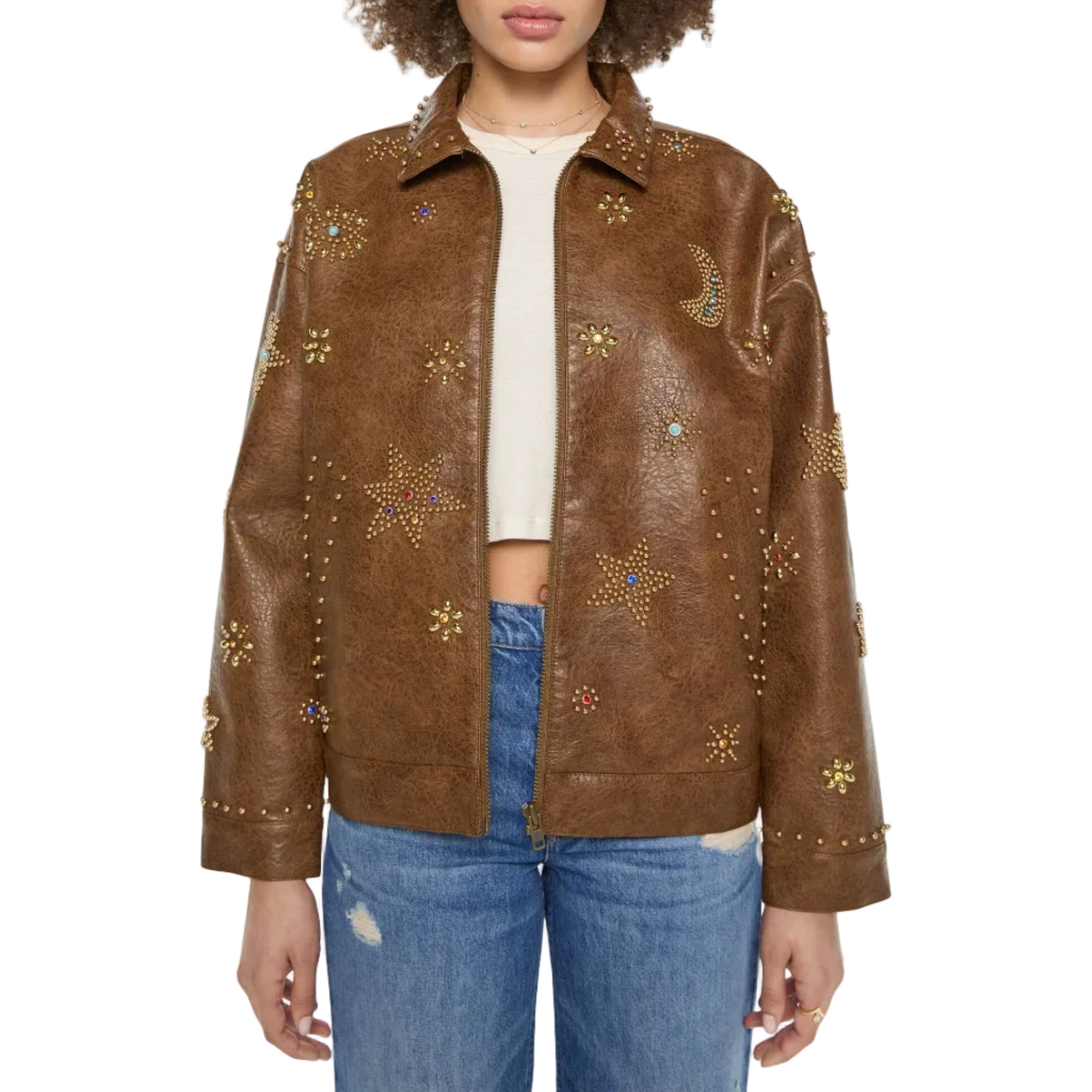 A model wearing a brown faux-leather jacket embellished with gold star and crescent moon studs, styled with a cream crop top and blue jeans against a plain white background.