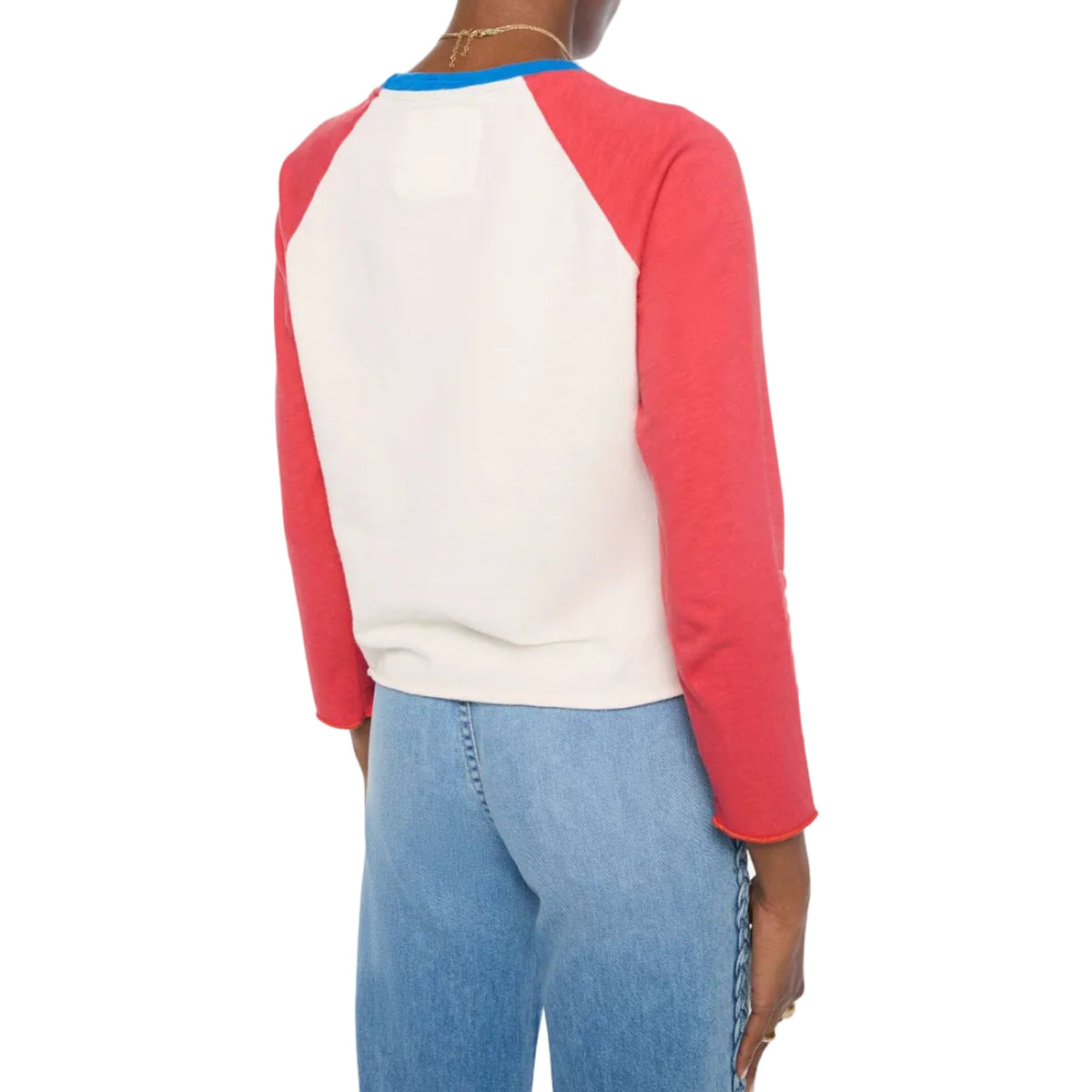 Person wearing a red and white baseball-style shirt with blue jeans on a white background