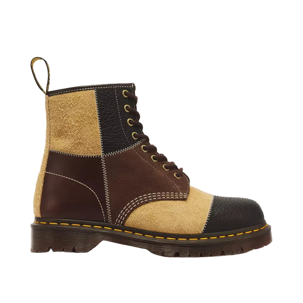 A patchwork ankle boot with dark brown leather, tan suede, and black suede panels, featuring a pull tab, lace-up front, and a classic yellow welt stitch on a white background.