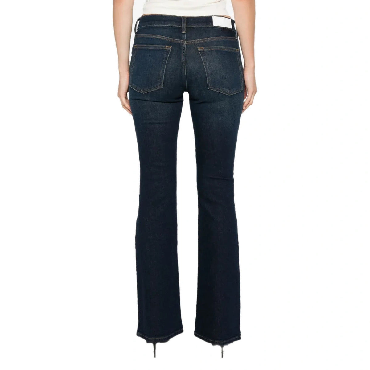 Back view of the Micro Boot Jean on a model, showing the back pockets, a waistband label patch and the bootcut hem.