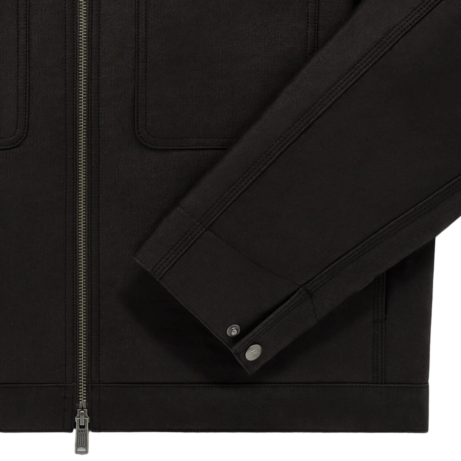 Close-up of a black jacket with zippers and buttons on a white background