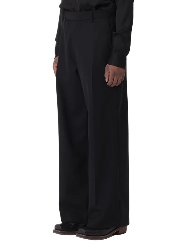 Man wearing a black shirt and pants on a white background